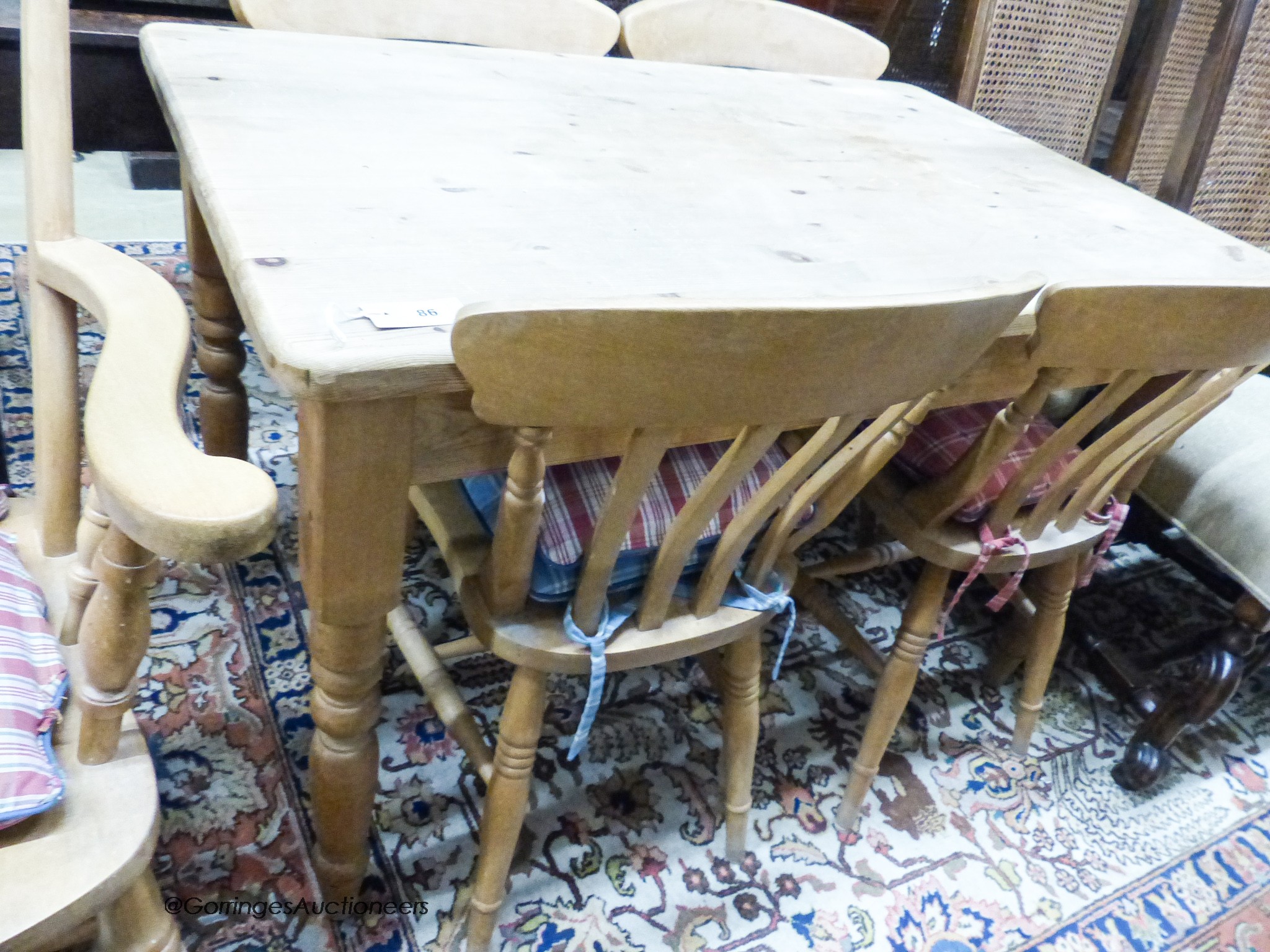 A small Victorian style rectangular pine kitchen table, width 120cm, depth 76cm, height 77cm together with a Windsor beech armchair and two kitchen chairs